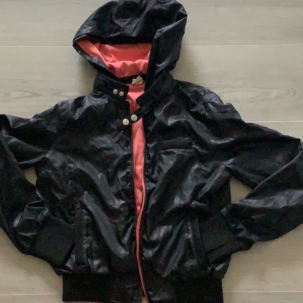 Women bomber style jacket with hoodie. Shell is 100% polyester. Lined.